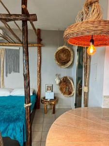 a bedroom with a canopy bed and a table at Departamentos Maya in Isla Mujeres
