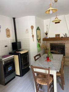 a kitchen with a table and a stove at Casa rio Lera in Amandola +36 photos