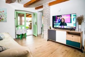 a living room with a large flat screen tv at House Ladonja with private pool in Bale