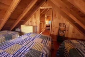 a bedroom with two beds in a attic at Cozy Cove Cottage Winter Rental Available in Belgrade