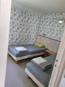 a small room with two beds and a table at Camping des ch tis in Saint-Silvain-Bellegarde