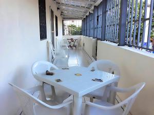 a white table and chairs on a balcony at Miami Studios DR in Santo Domingo