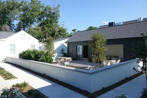 a backyard of a house with a white wall at Whitetail Court Hotel in Fredericksburg