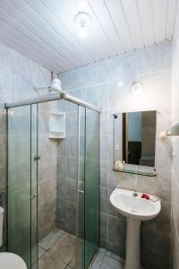 a bathroom with a glass shower and a sink at Pousada Lenda das Águas in Fernando de Noronha