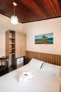 a bedroom with a white bed in a room at Pousada Lenda das Águas in Fernando de Noronha