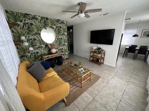 a living room with a couch and a flat screen tv at Miami's Cozy Tropical Getaway in Miami