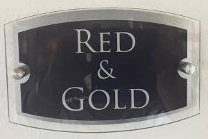 a sign with the words red and gold on it at Yr Hen Felin - The Old Mill B&B in Morfa Nefyn