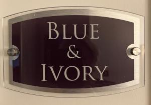 a sign that says blue and ivory on a wall at Yr Hen Felin - The Old Mill B&B in Morfa Nefyn