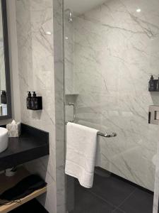 a bathroom with a shower and a white towel at Hotel Catedral in Mexico City +37 photos