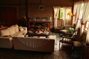 a living room with a couch and a table at Criollo Lodge in El Hoyo