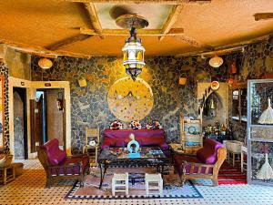 a living room with a couch and chairs at Riad Chay & Boutique in Ouarzazate