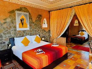 a bedroom with a large bed in a room at Riad Chay & Boutique in Ouarzazate