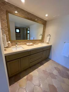 a bathroom with a sink and a mirror at Golfers' Oasis Villa in Cabo San Lucas