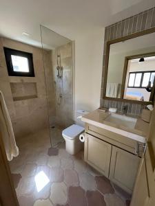 a bathroom with a shower and a toilet and a sink at Golfers' Oasis Villa in Cabo San Lucas +8 photos