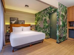 Cama ou camas em um quarto em Grand Mercure SP Itaim Bibi