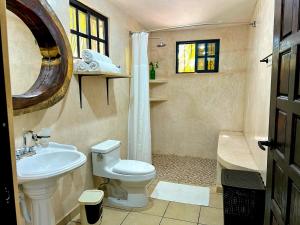 a bathroom with a white toilet and a sink at Casa Chukum en Rio Lagartos in Río Lagartos +36 photos