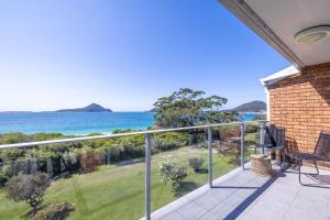 a balcony with a view of the ocean at Luskin Lodge 11 stunning water views in Shoal Bay