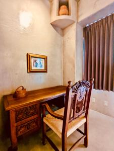 a home office with a wooden desk and a chair at Alegria Suites Centro Historico in Todos Santos