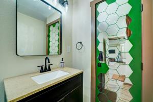 a bathroom with a sink and a shower with a mirror at Ferny Creek Cottage in Blairsville +18 photos