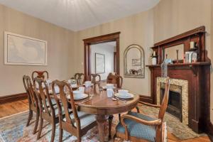 a dining room with a table and a fireplace at 4 Bed Duplex near Goodale Park in Columbus +39 photos
