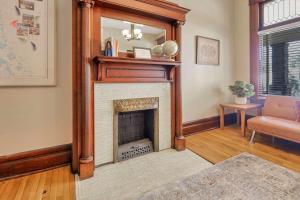 a living room with a fireplace with a mirror at 4 Bed Duplex near Goodale Park in Columbus