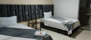 Letto o letti in una camera di Hotel Empresarial