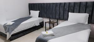 Postel nebo postele na pokoji v ubytování Hotel Empresarial