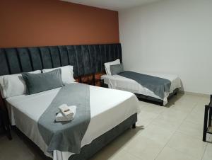 Postel nebo postele na pokoji v ubytování Hotel Empresarial