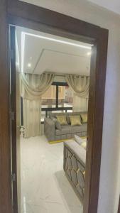 a mirror reflection of a living room with a couch at Selouane in Nador +18 photos