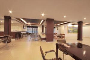 a large room with chairs and tables in a building at Paragon Suites Resort in Jomtien Beach