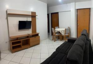 a living room with a couch and a flat screen tv at Apartamento com mobília nova 402 in Francisco Beltrão