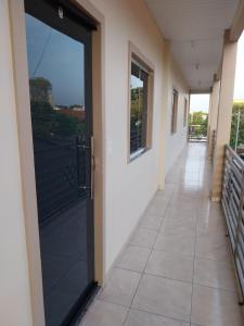 an empty hallway with a door to a balcony at APT Raphis C in Santarém +4 photos