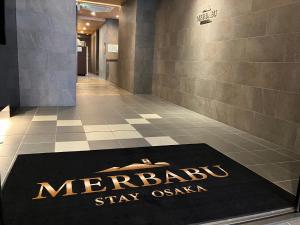 a welcome mat on the floor of a lobby at MERBABU STAY OSAKA in Osaka