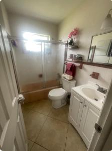 a bathroom with a shower and a toilet and a sink at Private room with shared bathroom in Hollywood area in Dania Beach