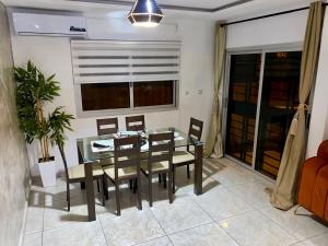 a dining room with a glass table and chairs at 2Bed Abidjan Apartment- Relax Explore & Unwind in Cocody