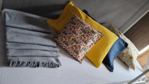 a group of pillows sitting on top of a bed at Hostel Aprisco São Paulo in São Paulo