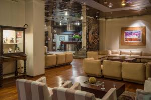 a living room with a couch and a table and chairs at Mini Palace Hotel in Viterbo