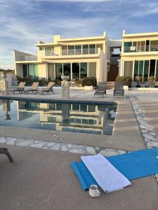 a building with a swimming pool in front of a house at Palacio Blanco Luxury Villa 2 in La Ventana