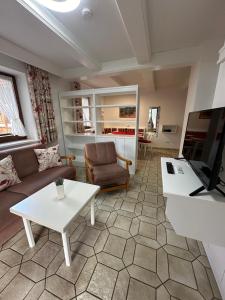 a living room with a couch and a table at Gästehaus Deml in Berchtesgaden