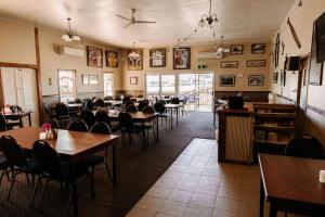 a restaurant with tables and chairs in a room at Wagon Wheel Motel in Cloncurry