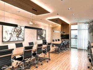 une salle de conférence avec une longue table et des chaises dans l'établissement Nosso Apê 915: Piscina | Academia | Coworking - NA2103, à Juiz de Fora