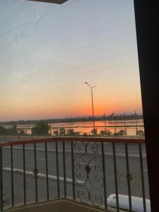 a view of a sunset from a balcony at Luxor Apparment in Al Bayāḑīyah