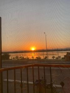 a sunset from a balcony with a view of a road at Luxor Apparment in Al Bayāḑīyah