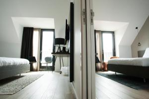 Een bed of bedden in een kamer bij Hotel Katoen