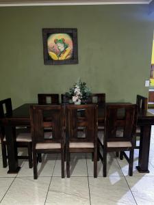 a dining room with a wooden table and chairs at Coconut Casa 10 Min from La Fortuna with AC - Fast Wi-Fi - Private Parking in a Friendly Neighborhood in Fortuna