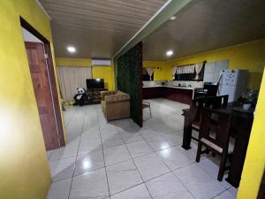 a kitchen and living room with a table and a couch at Coconut Casa 10 Min from La Fortuna with AC - Fast Wi-Fi - Private Parking in a Friendly Neighborhood in Fortuna