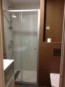 a shower with a glass door in a bathroom at Joanic Apartment Escorial in Barcelona