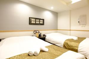 Postel nebo postele na pokoji v ubytování 東京新橋579 Shinbashi Residence