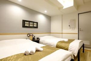 Postel nebo postele na pokoji v ubytování 東京新橋579 Shinbashi Residence