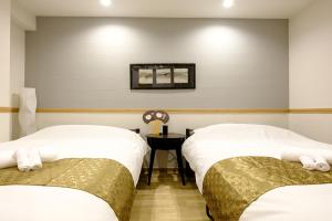 Postel nebo postele na pokoji v ubytování 東京新橋579 Shinbashi Residence